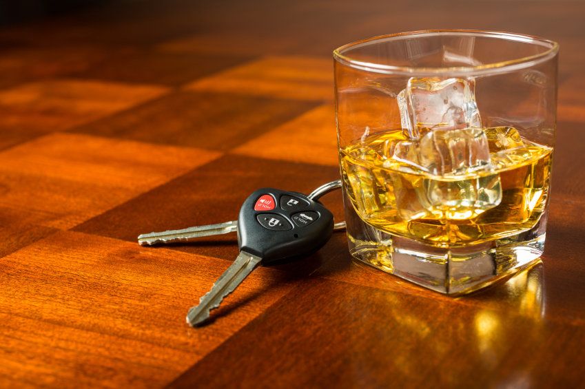 Glass of whiskey next to car keys